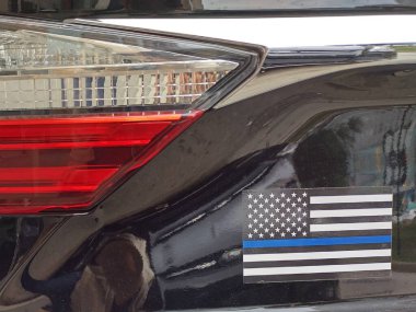 Baltimore, MD, United States, September 17, 2024: Blue line American flag at back of car. Shows support for law enforcement. The 