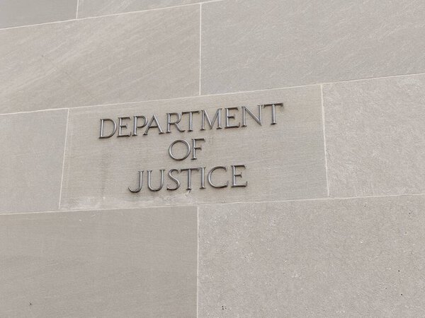Washington DC, USA, September 16, 2024: Closeup of sign of US Department of Justice (DOJ) at facade of Robert F. Kennedy Building. DOJ enforces the law and defends the interests of the United States.