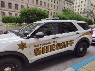 Baltimore, MD, United States, September 17, 2024: Baltimore City Sheriffs police patrol car parked at side of street at daytime in citycenter of Baltimore, Maryland. clipart