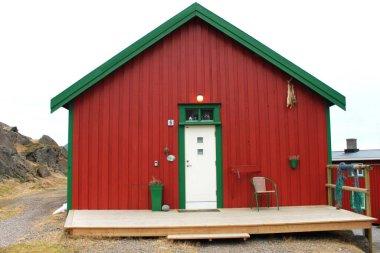 Bodo, Nordland, Norveç - 12 Nisan 2019: Tipik Norveç balıkçılarının evi ahşap tahtalardan yapılmış kırmızı ve yeşile boyanmış balık ve davetkar sandalye. Nordland 'daki Norveçli Bodo kasabası.