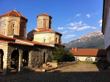 Sveti Naum, North Macedonia - October 07, 2011: Yard of ancient monastery of Saint Naum in warm sunlight and view to Galiica mountain. clipart