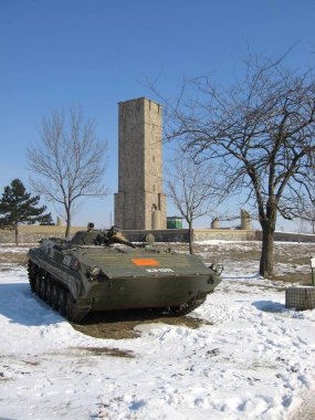 Pristina, Kosovo - January 28, 2006: Slovakian BVP tracked infantry fighting vehicle in KFOR service guarding Gazimestan Monument in Kosovo polje. clipart