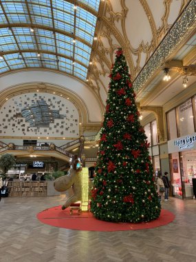 Antwerp, Flanders, Belgium - January 09, 2025: Beautifully renovated Stadsfeestzaal, a traditional shopping centre, with christmas tree and decoration. clipart