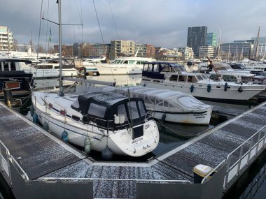 Antwerp, Flanders, Belgium - January 09, 2025: Winterized private yachts at Willemdok in Eilandje in downtown Antwerp on a chilling winter day with cloudy sky. clipart