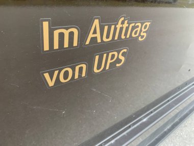 Ganserndorf, Lower Austria - January 12, 2025: Detail of inscription found on side wall of a parked delivery truck saying in German 