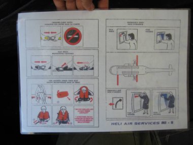 Pristina, Kosovo - June 01, 2006: Safety Card of Mil Mi-8P operated by Heli Air Services for United Nations Interim Administration Mission in Kosovo. clipart