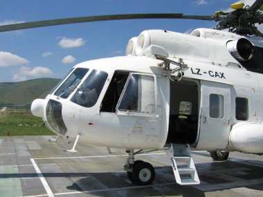 Pristina, Kosovo - June 01, 2006: Mil Mi-8P heli in white UN livery operated by United Nations Interim Administration Mission in Kosovo at Prishtina International Airport heli pad. clipart