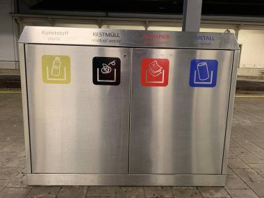 Ganserndorf, Lower Austria - January 22, 2025: Passengers are requested to separate their garbage in modern waste paper baskets on platform of Austrian Railway station. clipart