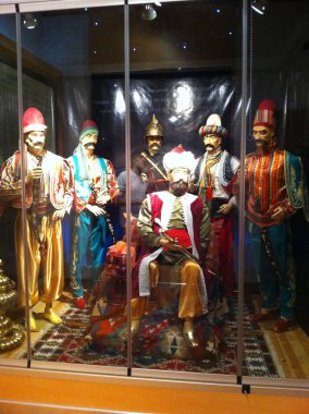 Mazgit, Pristina, Kosovo - August 20, 2011: Historical ottoman figures in splendid traditional costumes in Museum at Tomb of Sultan Murad I on Kosovo field. clipart