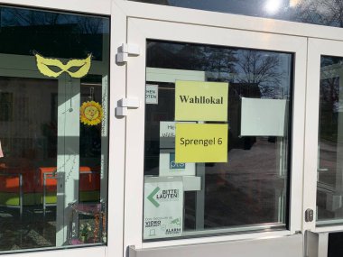 Ganserndorf, Lower Austria - January 26, 2025: Entrance door to polling station established in an Austrian school building during Municipal council election. clipart