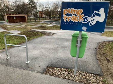 Ganserndorf, Lower Austria - January 28, 2025:Entrance to newly built Paved Pump track. Open to bicycle riders, skateboarders, in-line skaters, and foot-powered scooters. clipart