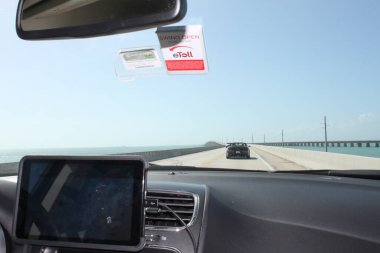 Florida Keys, FL, US - February 12, 2020: View through windshield on Overseas Highway U.S. Route 1 on the Florida Keys heading South. clipart