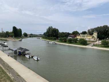 Gyor, Hungary, August 4, 2024: Estuary of Raba Moson-Danube with moored boats. Moson arm of the Danube, meandering southern arm in Hungary, where the south bank tributaries, Raba and Rabca, converge. clipart