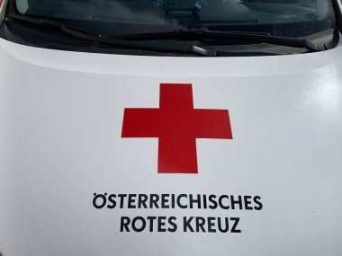 Gaenserndorf, Aşağı Avusturya - 01 Mart 2025: Ambulans aracının motor kaputunda Avusturya Kızıl Haçı (RK) işaret eden Almanca yazı ve logo.