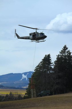 GUePl Geyerhof, St. Peter, Yukarı Avusturya - 12 Mart 2025: Avusturya Hava Kuvvetleri Agusta Bell AB-212, 5D-HO, Hafif Taşımacılık Helikopter Filosu, havada asılı duran ve metal yapısını yerden kaldıran.