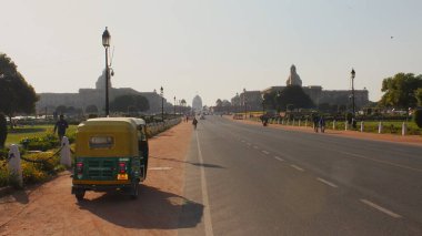 Yeni Delhi, Hindistan - 7 Mart 2019: Tipik bir CNG oto çekçek aracından etkileyici Kartavya Yolu boyunca İçişleri ve Dış İşleri Bakanlığı ve Cumhurbaşkanlığı Rashtrapati Bhavan.