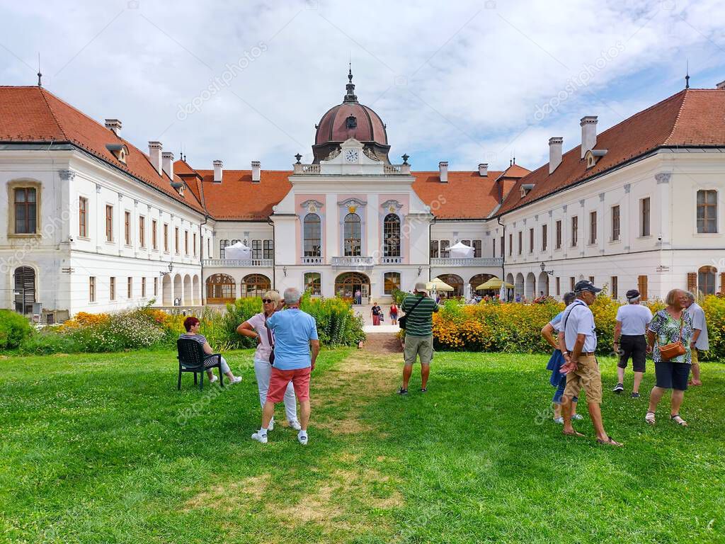 Godollo, Pest County, Hungary -  August 5, 2024: Tourists in park in front of courtyard of Royal Palace of Godollo. Favorite summer residence of Empress Sisi.