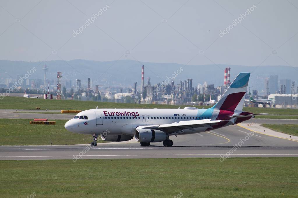 Schwechat, Lower Austria - April 20, 2025: Eurowings 9H-EXS Airbus A319-132 retarding with deployed reverser and extended speed brakes after landing on runway 16 of Vienna International airport.