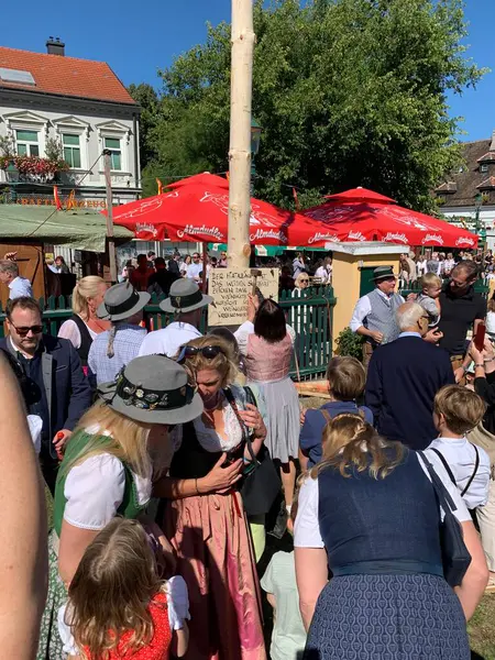 Viyana, Avusturya - 24 Ağustos 2025: Geleneksel Viyana şarap üreticisi festivali Neustifter Kirtag sırasında ziyaretçiler sembolik Hiatabaum 'a (koruyucu ağaç) bir çivi çaktılar. Son çekiç darbesi kaybeder.