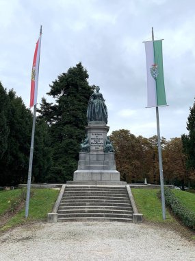 Wiener Neustadt, Lower Austria - September 27, 2025: Maria-Theresien-Denkmal (Maria Theresa Monument) on campus of Theresian Military Academy. Flags of Austrian federal states Salzburg and Styria.