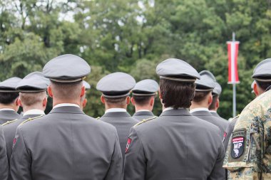 Wiener Neustadt, Lower Austria - September 27, 2025: Uniformed Austrian Armed Forces officer cadets with peaked caps standing in formation during 