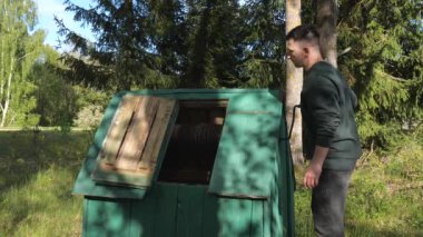 Fetching water from well by hand, fresh pure drinking mineral water, fresh resource. Rural belarusian village well splashing, scarcity ground water. Belarus