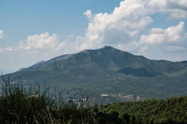 Gökyüzünde birkaç bulut olan bir dağ