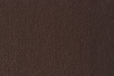 Kahverengi renk, tekstil kumaş kumaş dokusu arkaplanı. Soyut tek renkli koyu kahverengi keçeli arka plan.