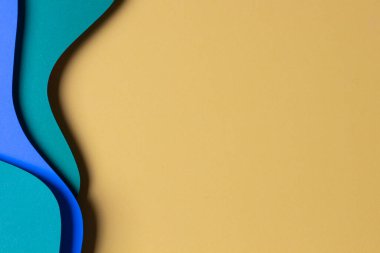 Soyut renkli kağıt dokusu arkaplanı. Asgari kağıt, geometrik şekil ve çizgilerin sarı, açık mavi ve yeşil renkli katmanlarını kesiyor. Üst görünüm, alanı kopyala