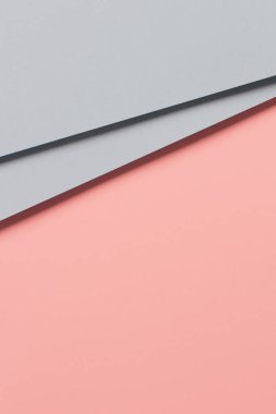 Soyut renkli kağıt dokusu arkaplanı. Pastel pembe ve açık mavi renkte minimal geometrik şekiller ve çizgiler.