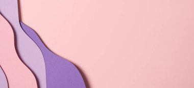 Abstract colored paper texture background. Minimal paper cut composition with layers of geometric shapes and lines in pastel pink and violet purple colors. Top view, copy space.