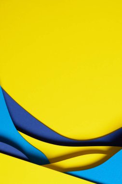 Abstract colored paper texture background. Minimal paper cut composition with layers of geometric shapes and lines in light blue, navy blue, yellow colors.