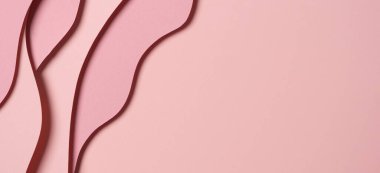 Abstract colored paper texture background. Minimal paper cut composition with layers of geometric shapes and lines in pastel pink colors. Top view, copy space.