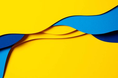 Abstract colored paper texture background. Minimal paper cut composition with layers of geometric shapes and lines in light blue, navy blue, yellow colors.