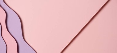 Abstract colored paper texture background. Minimal paper cut composition with layers of geometric shapes and lines in pastel pink and violet purple colors. Top view, copy space.
