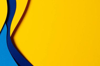 Abstract colored paper texture background. Minimal paper cut composition with layers of geometric shapes and lines in light blue, navy blue, yellow colors.