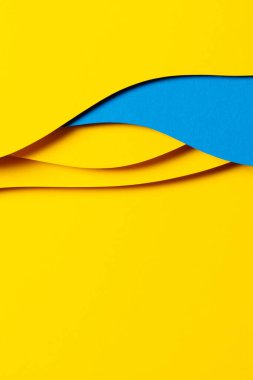 Abstract colored paper texture background. Minimal paper cut composition with layers of geometric shapes and lines in light blue and yellow colors.