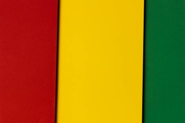 Abstract geometric red, yellow, green color paper background. Black History Month color background with copy space for text