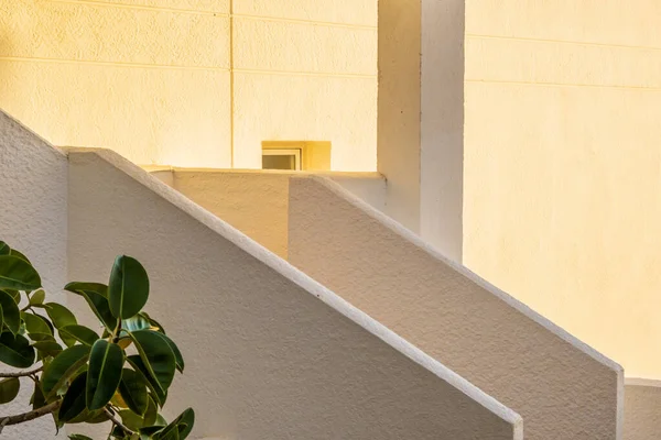 Architectural detail of white mediterranean house by the sea in sunny day. Minimal architecture building detail in Spanish coastline by Mediterranean sea in Spain.