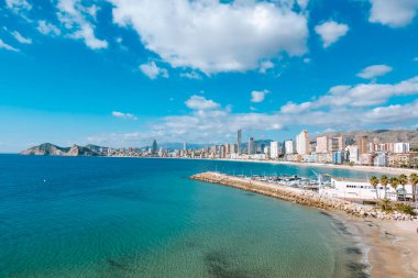 Bendorm, Spain - February 1, 2023: Panorama of Benidorm city skyline with Mediterranean sea, Poniente beach and mountains in the background.