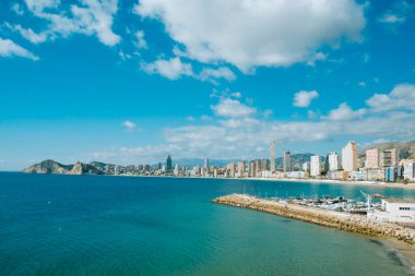 Bendorm, Spain - February 1, 2023: Panorama of Benidorm city with Mediterranean sea, Benidorm skyscrapers, hotels and mountains in the background.