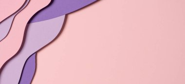 Abstract colored paper texture background. Minimal paper cut composition with layers of geometric shapes and lines in pastel pink and violet purple colors. Top view, copy space.