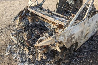 Car after the fire. Iron parts of burnt out car. Completely burnt passenger car due to accident, bad technical condition, breakdown.