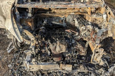 Car after the fire. Iron parts of burnt out car. Completely burnt passenger car due to accident, bad technical condition, breakdown.