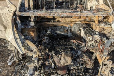 Car after the fire. Iron parts of burnt out car. Completely burnt passenger car due to accident, bad technical condition, breakdown.