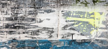 Old grunge torn collage urban street posters creased crumpled paper placard texture background. Ripped faded paper backdrop surface placard.