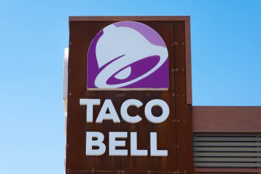 Finestrat, Spain - March 2, 2023: Taco Bell logo on Taco Bell restaurant wall. Taco Bell is American-based chain of fast food restaurants, witch serve variety of Mexican-inspired foods.