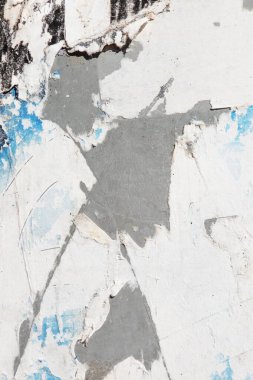 Old grunge torn collage urban street posters creased crumpled paper placard texture background. Ripped faded paper backdrop surface placard.