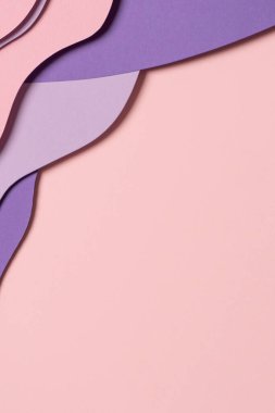 Abstract colored paper texture background. Minimal paper cut composition with layers of geometric shapes and lines in pastel pink and violet purple colors. Top view, copy space.