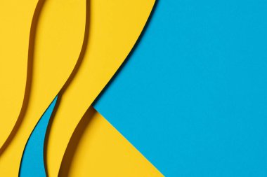 Abstract colored paper texture background. Minimal paper cut composition with layers of geometric shapes and lines in light blue, navy blue, yellow colors.